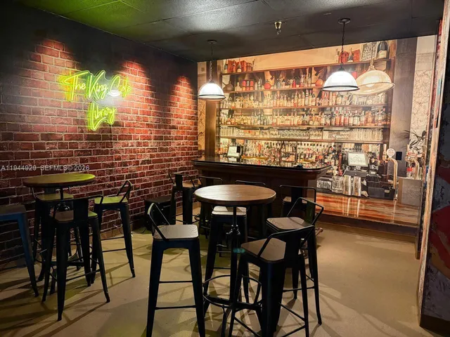 a dining room with furniture window and wooden floor