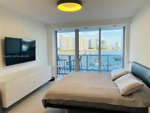 a bedroom with a bed and a flat screen tv