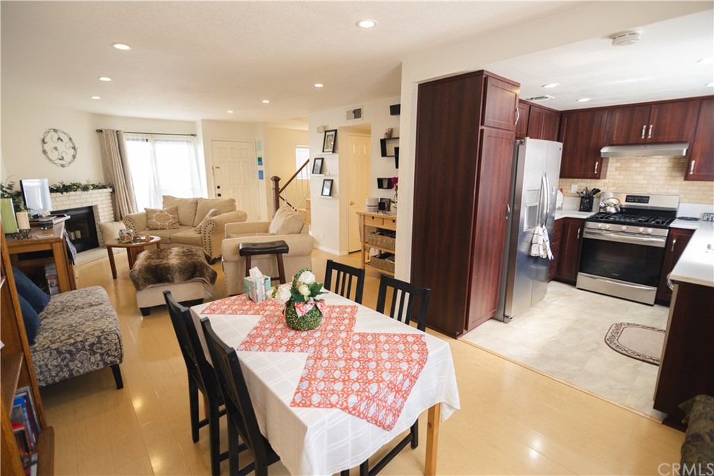 1812 Huntington Drive Duarte, CA 91010 - Photo 13 of 28 a kitchen with stainless steel appliances granite countertop a refrigerator a stove a sink dishwasher a dining table and chairs with wooden floor