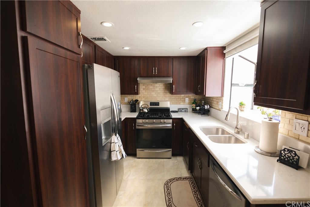 1812 Huntington Drive Duarte, CA 91010 - Photo 14 of 28 a kitchen with stainless steel appliances a refrigerator sink and stove