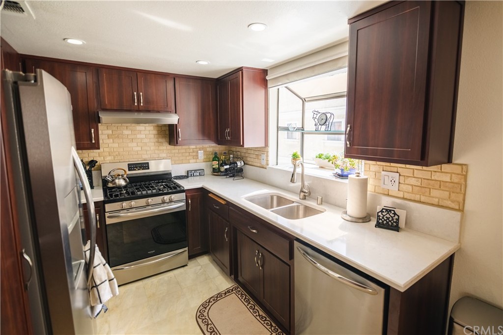 1812 Huntington Drive Duarte, CA 91010 - Photo 15 of 28 a kitchen with stainless steel appliances a sink a stove a refrigerator cabinets and a window