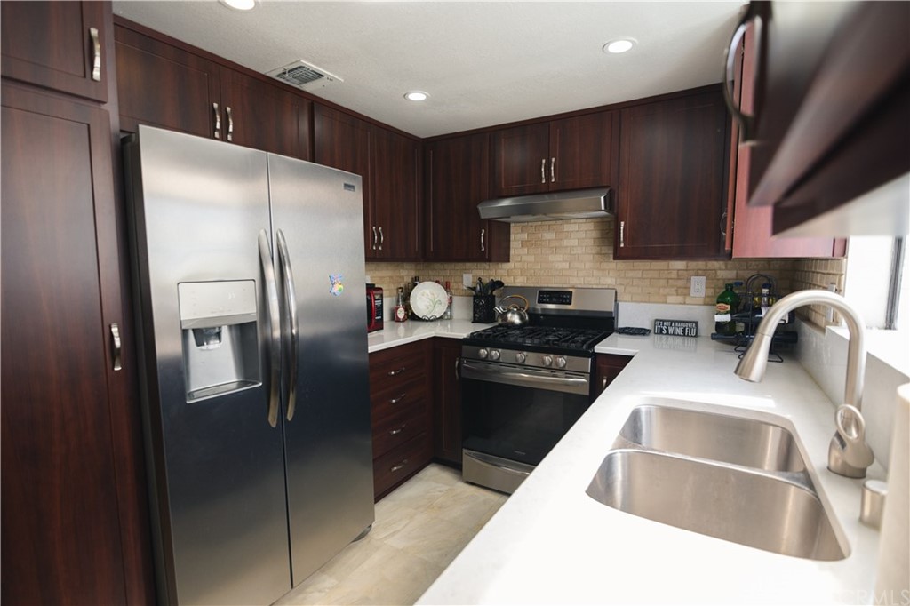 1812 Huntington Drive Duarte, CA 91010 - Photo 16 of 28 a kitchen with stainless steel appliances granite countertop a refrigerator a sink a stove and cabinets