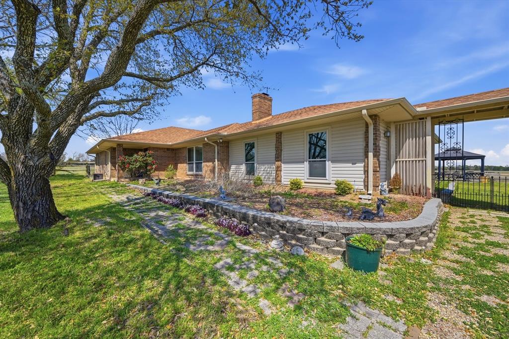 a front view of house with yard and outdoor seating