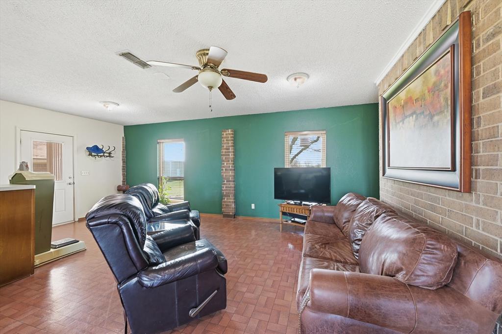 12099 County Road 1028 Blue Ridge, TX 75424 - Photo 17 of 36 a living room with furniture ceiling fan and a window