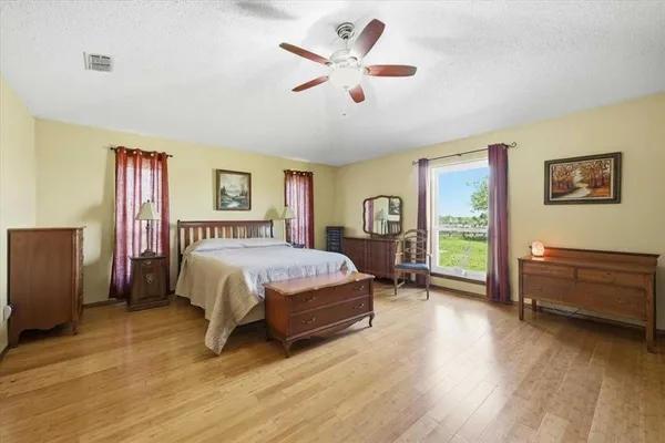 a spacious bedroom with a bed and a desk