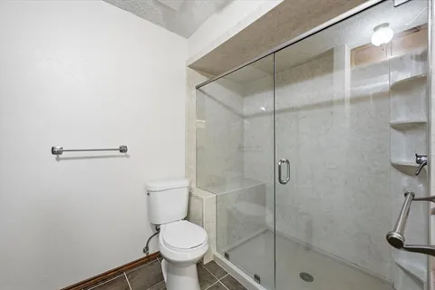a bathroom with a toilet and a shower
