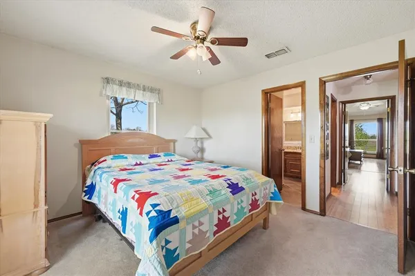 a bedroom with a bed and a chandelier