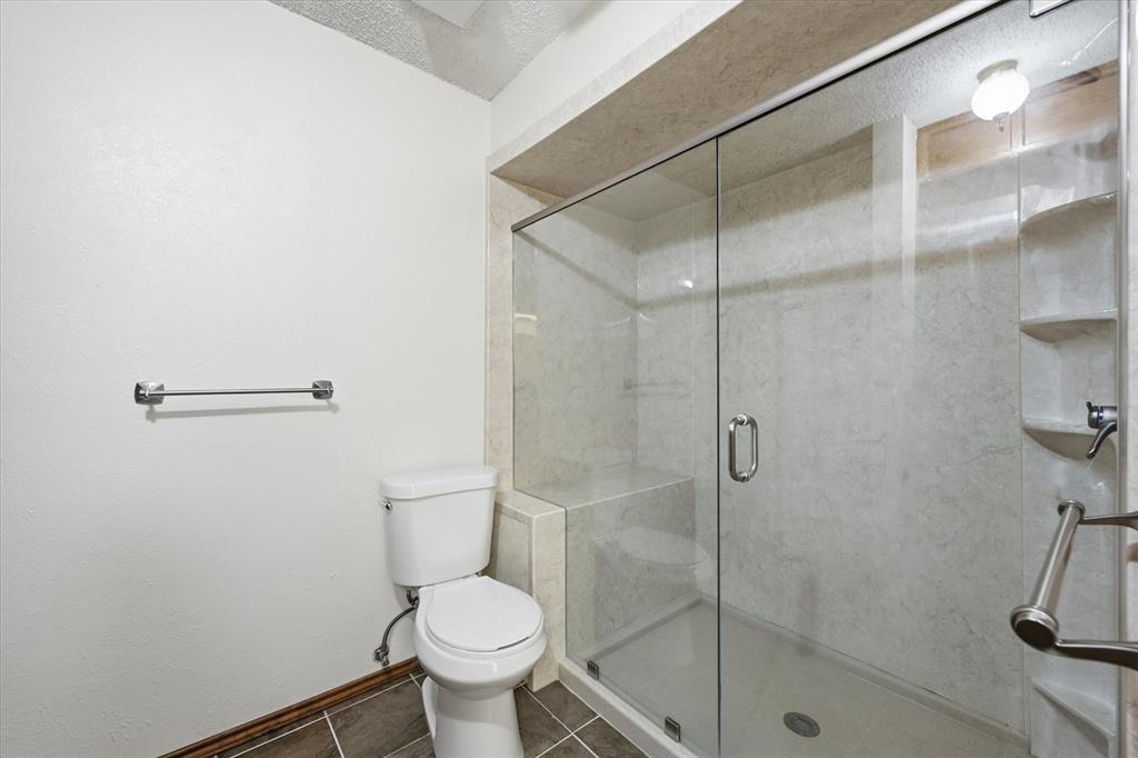 12099 County Road 1028 Blue Ridge, TX 75424 - Photo 22 of 36 a bathroom with a toilet and a shower