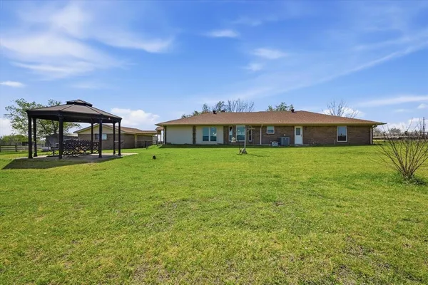 a view of a house with a big yard