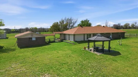 a view of a house with a yard and sitting area