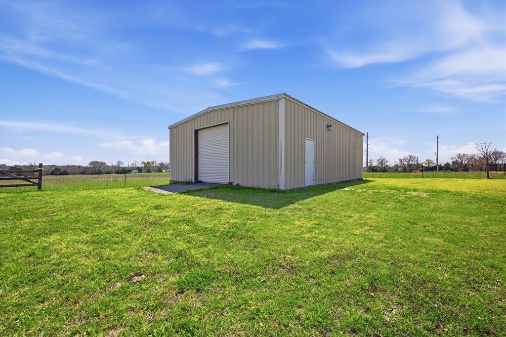 12099 County Road 1028 Blue Ridge, TX 75424 - Photo 28 of 36 a house with green field in front of it