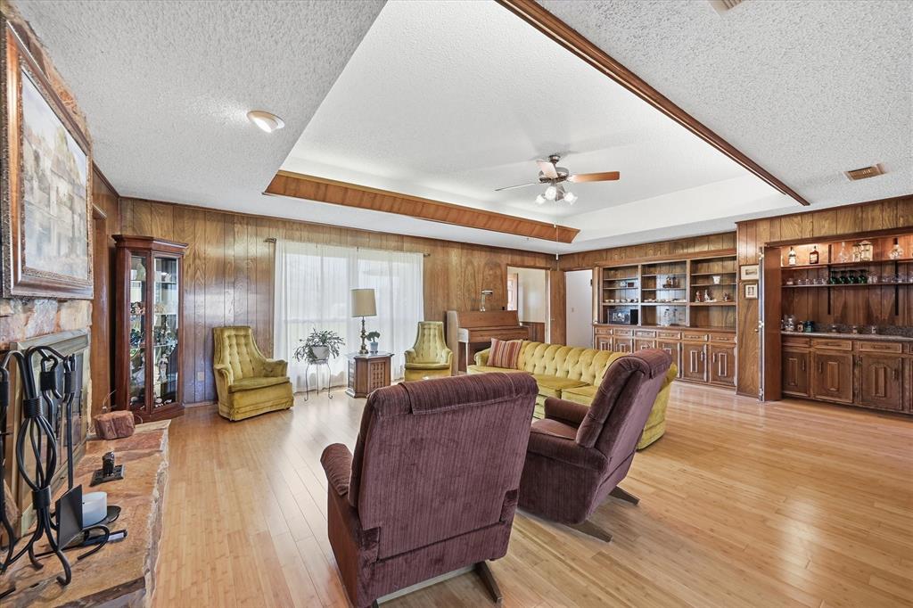 12099 County Road 1028 Blue Ridge, TX 75424 - Photo 6 of 34 a living room with furniture a fireplace and a flat screen tv