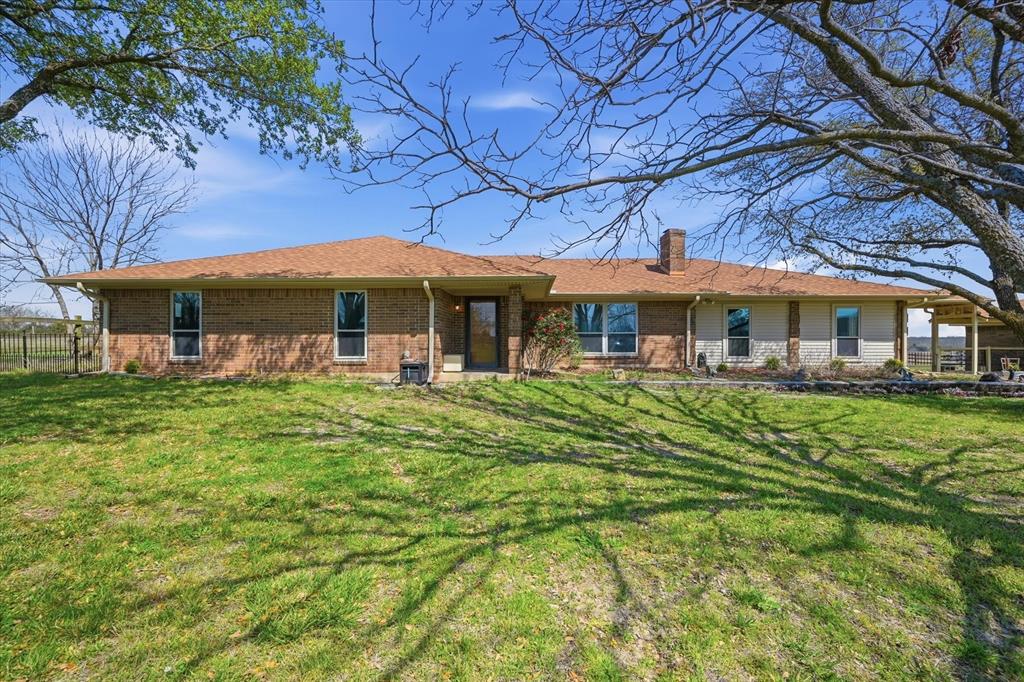 12099 County Road 1028 Blue Ridge, TX 75424 - Photo 6 of 36 a front view of a house with a garden