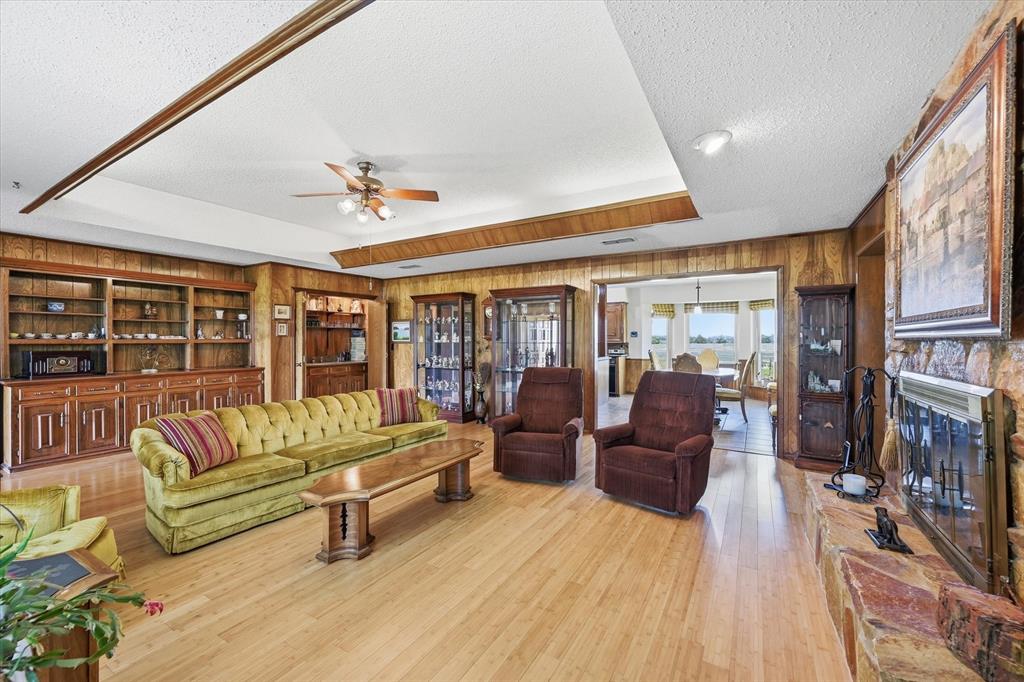 12099 County Road 1028 Blue Ridge, TX 75424 - Photo 7 of 34 a living room with furniture a fireplace and a flat screen tv