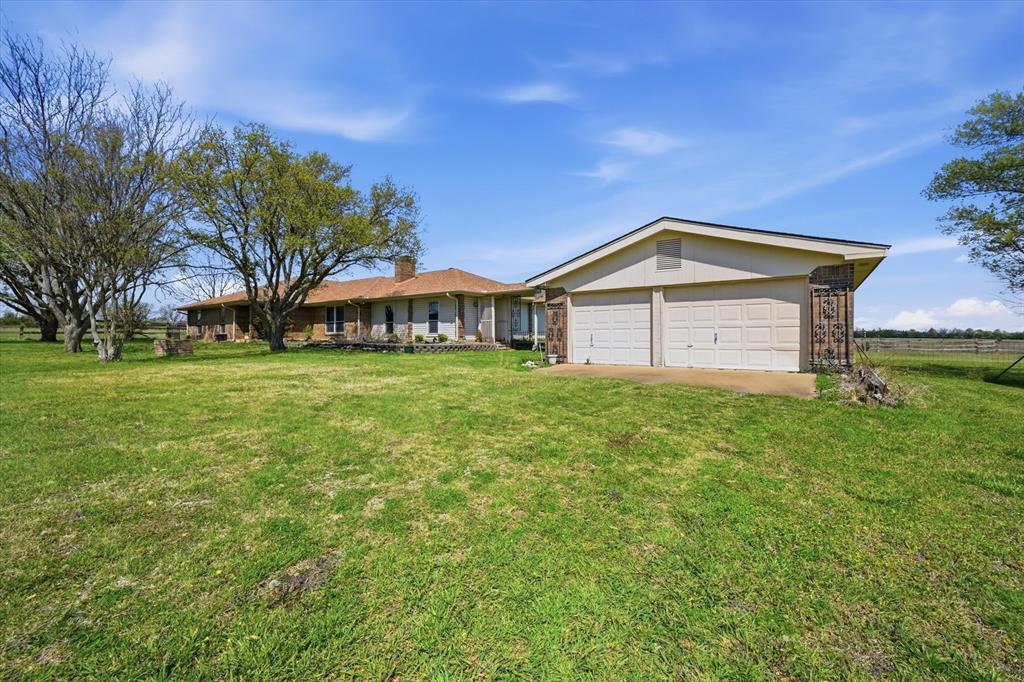 12099 County Road 1028 Blue Ridge, TX 75424 - Photo 7 of 36 a front view of a house with garden