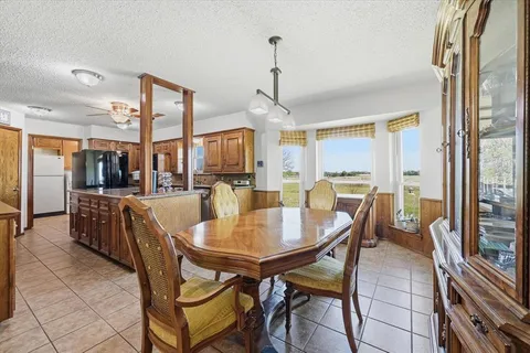 a dining room with furniture a chandelier and wooden floor