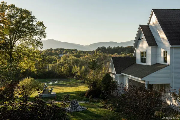 a view of a house with a yard and sitting area
