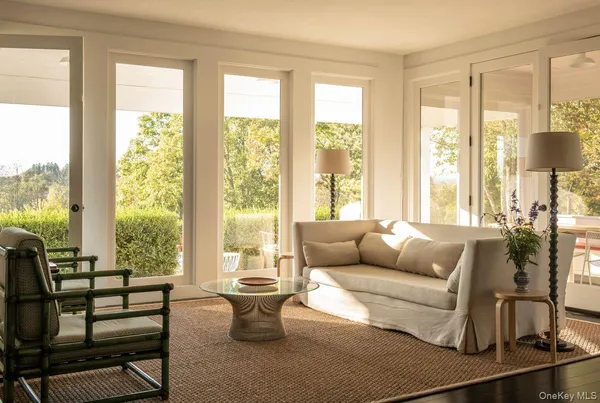 a living room with furniture and a floor to ceiling window
