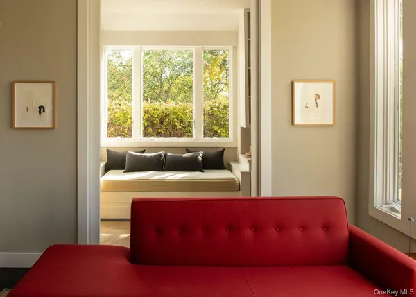 a bed sitting in a bedroom next to a window