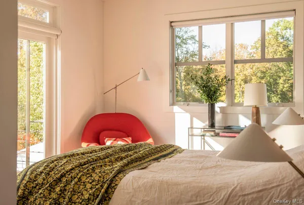 a bedroom with a bed and a large window