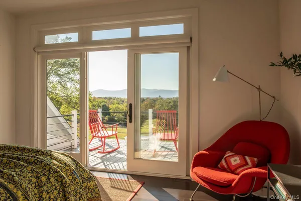 a bedroom with a bed and glass window