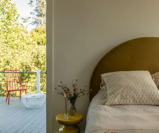 a bed sitting in a bedroom next to a window