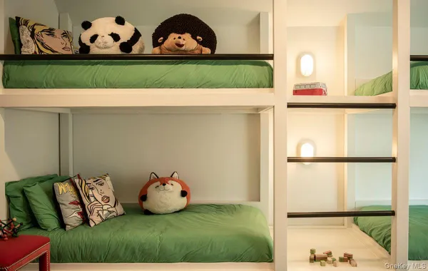 a bedroom with a bed and a painting on the wall