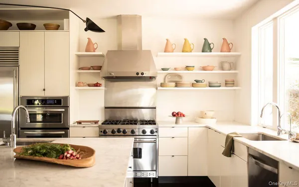 a kitchen with a stove a refrigerator and a sink