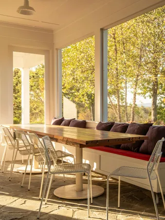 a living room with a table and a large window