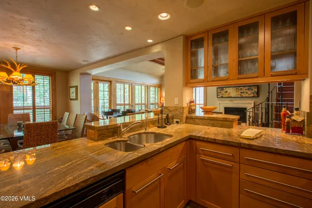 a kitchen with a sink and large windows