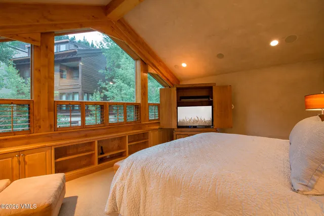 a bedroom with a large bed and a large window