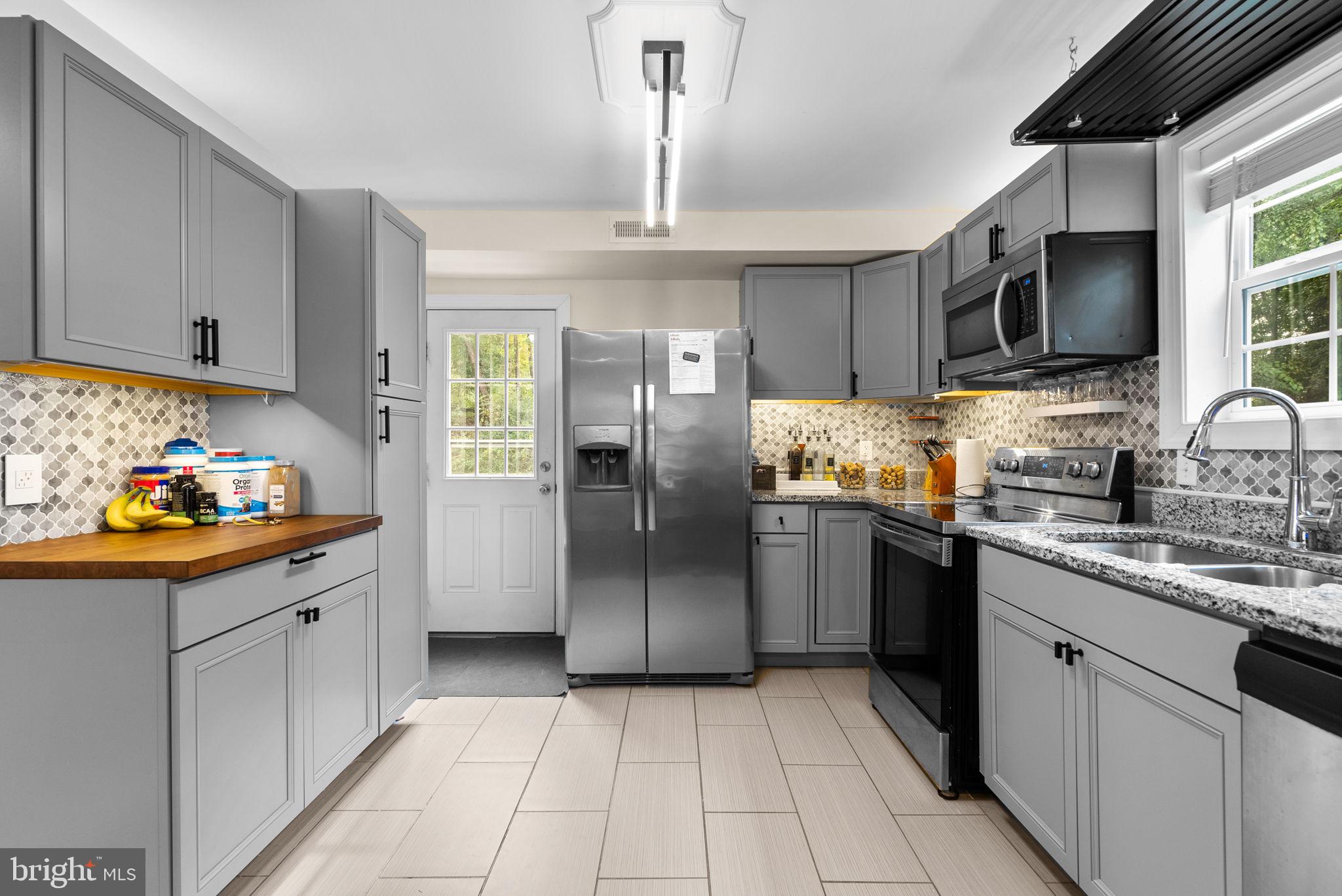 9621 Temple Hill Road Clinton, MD 20735 - Photo 12 of 48 a kitchen with stainless steel appliances granite countertop a refrigerator and a sink