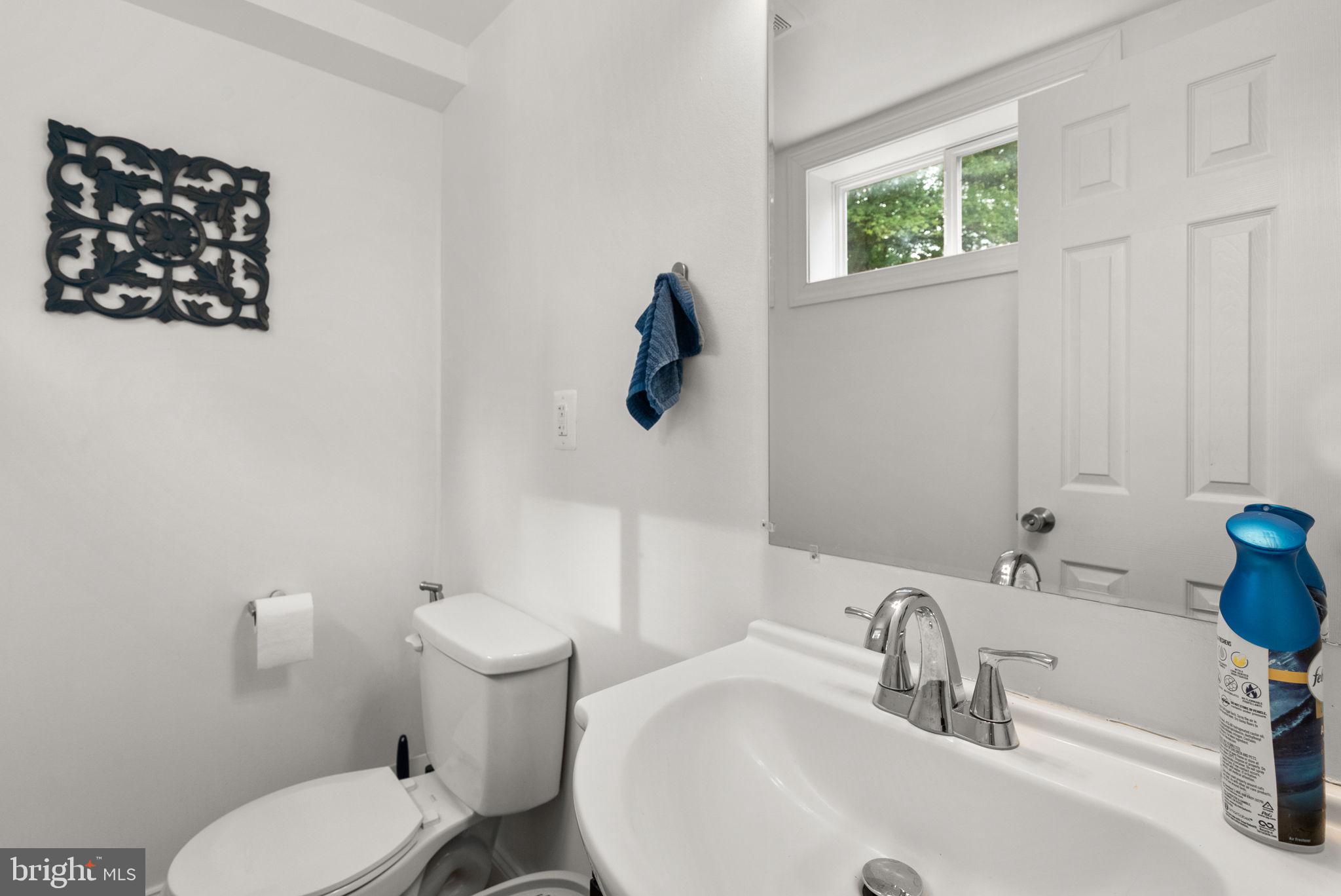 9621 Temple Hill Road Clinton, MD 20735 - Photo 20 of 48 a bathroom with a toilet sink and mirror