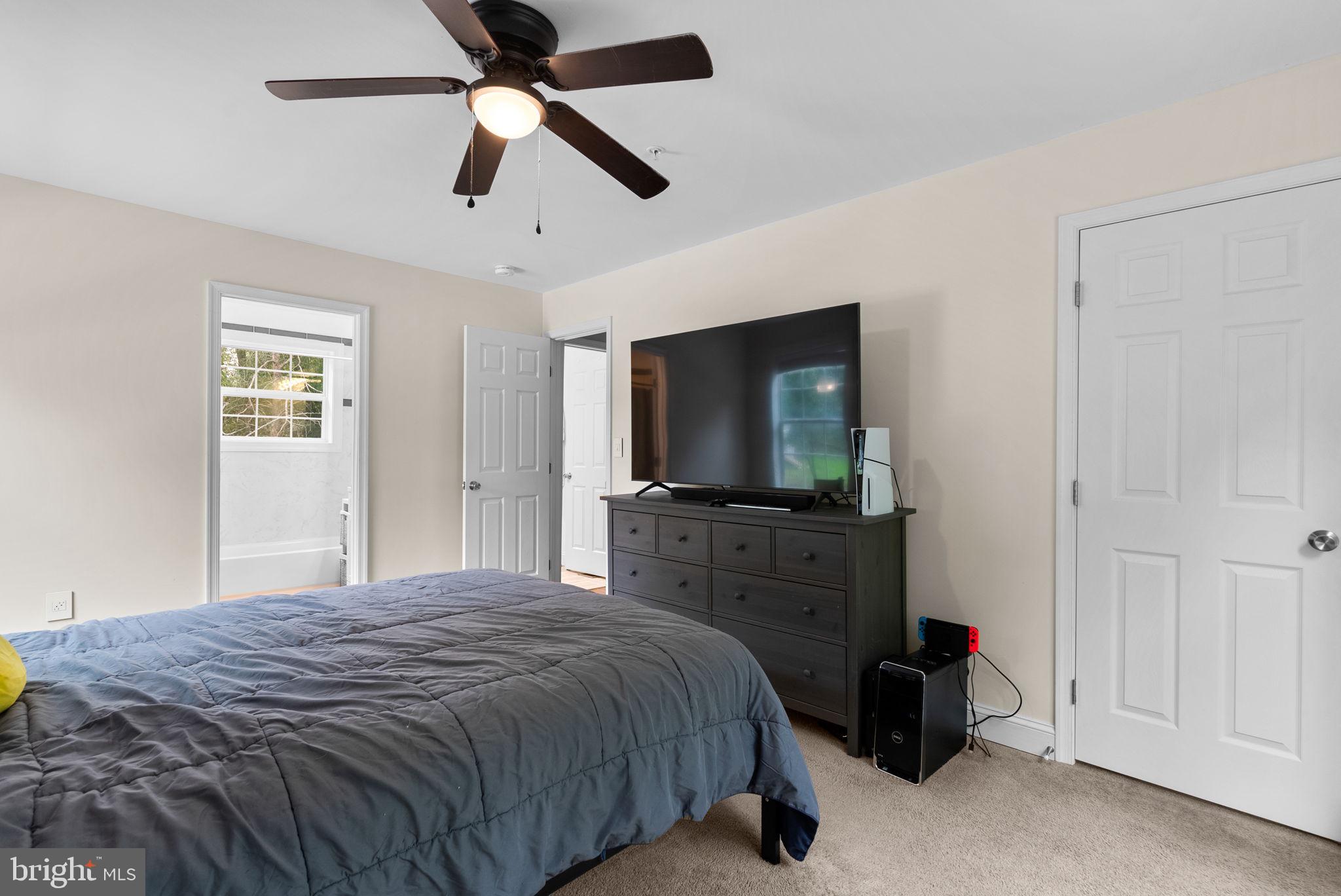 9621 Temple Hill Road Clinton, MD 20735 - Photo 25 of 48 a bedroom with a bed and a flat tv screen on dresser