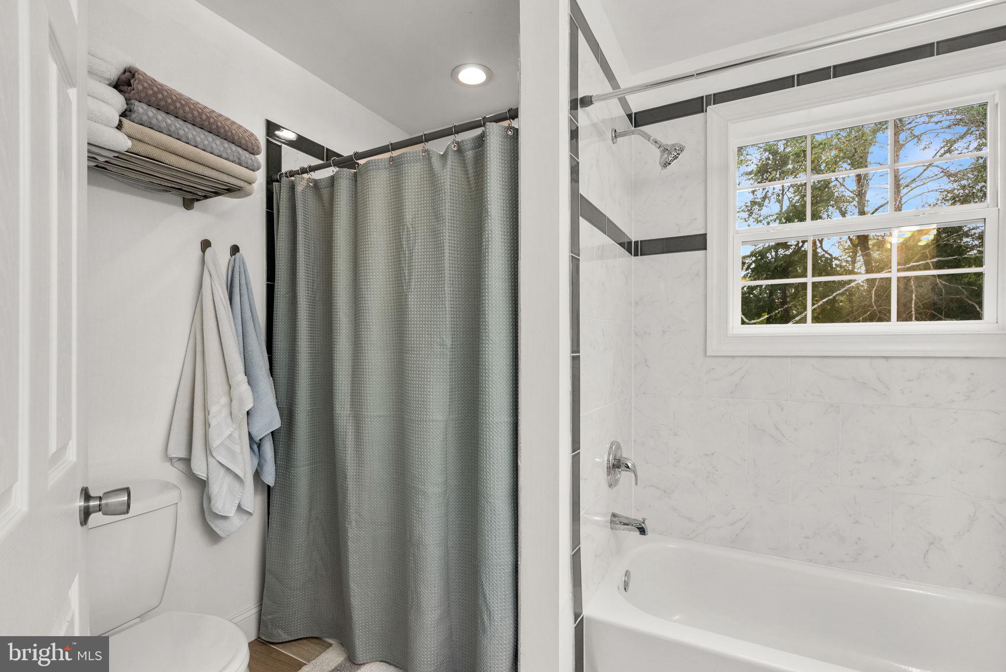 9621 Temple Hill Road Clinton, MD 20735 - Photo 29 of 48 a bathroom with a shower a bathtub and a shower