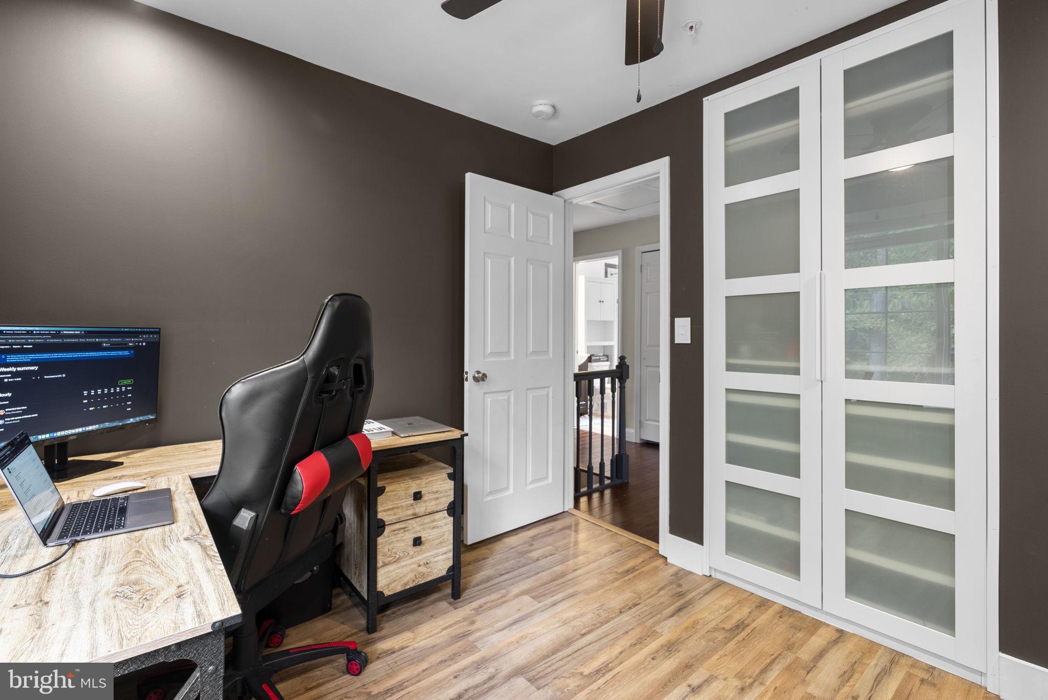 9621 Temple Hill Road Clinton, MD 20735 - Photo 32 of 48 a view of a bedroom with furniture and wooden floor