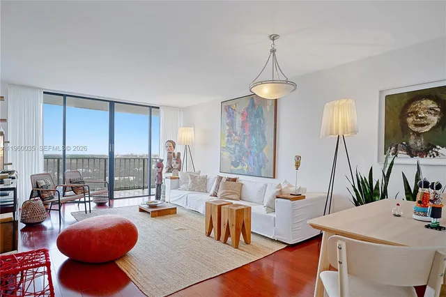 a dining room with furniture a rug and a chandelier