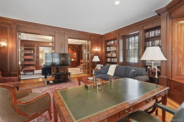 a living room with fireplace furniture and a large window