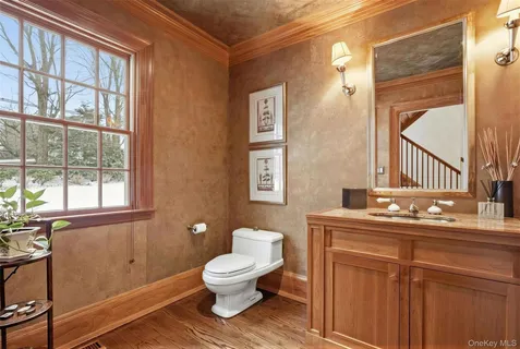 a bathroom with a toilet sink and mirror