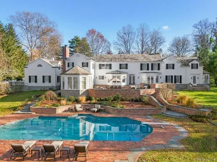 a view of a house with swimming pool and a yard
