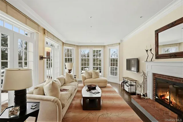 a living room with furniture a fireplace and a flat screen tv