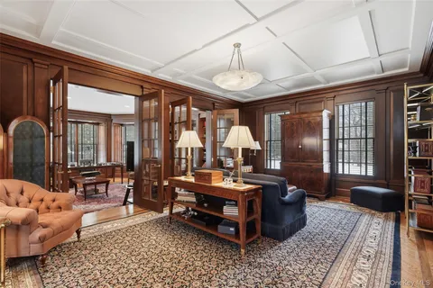 a living room with furniture a table and large window