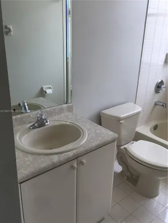 a bathroom with a toilet a sink and a mirror