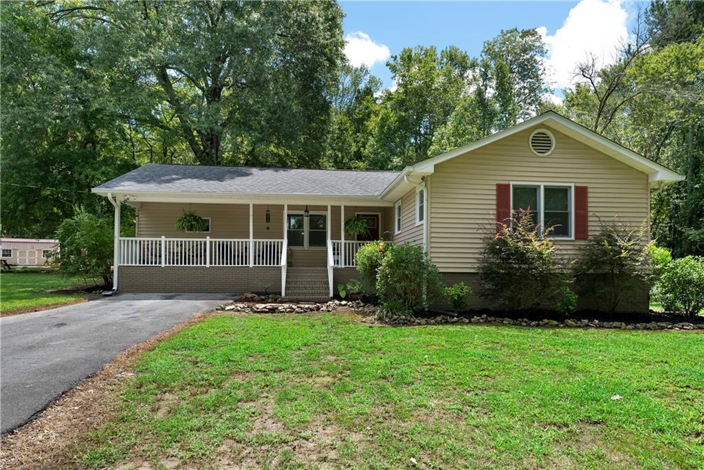 1246 Roland Hayes Parkway Southwest Calhoun, GA 30701 - Photo 1 of 1 a front view of a house with a yard and garden