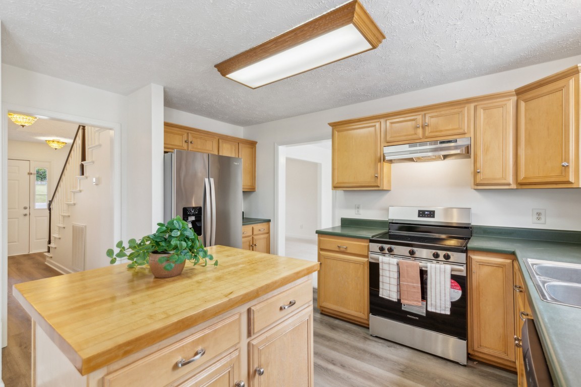 1948 Portway Road Spring Hill, TN 37174 - Photo 11 of 29 a kitchen with stainless steel appliances a stove and white cabinets