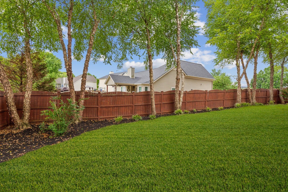 1948 Portway Road Spring Hill, TN 37174 - Photo 28 of 29 a view of a backyard with wooden fence and a large tree
