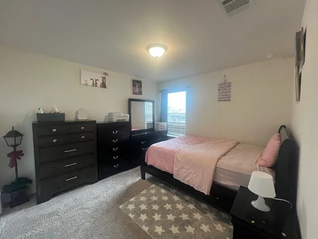 a bedroom with a bed and a dresser