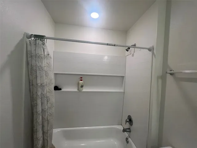 a bathroom with a shower and a tub