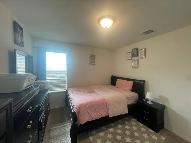 a bedroom with a bed and a tv