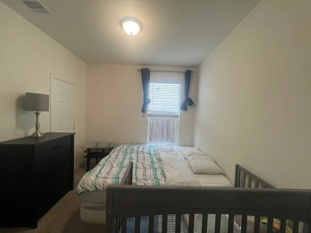 a bedroom with a bed and a table